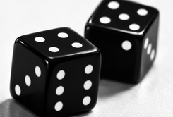 Two glossy black dice with white pips